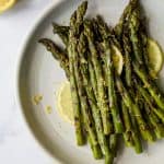 Grilled Asparagus topped with fresh Lemon zest, an easy paleo side dish that screams summer and takes minutes to make. You'll love how easy and flavorful this recipe is!