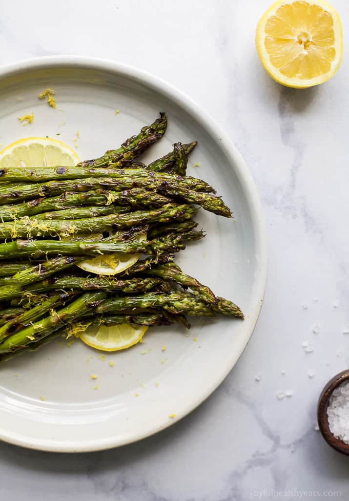 Grilled Asparagus topped with fresh Lemon zest on a plate