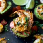 Easy 30 Minute Grilled Cilantro Lime Shrimp served in a Grilled Avocado Boat. This light & flavorful recipe makes the perfect party appetizer or main dish for the summer!