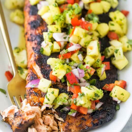 Grabbing a piece of flaky salmon with a fork.