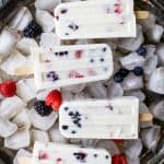 Paleo Berry Coconut Popsicles a sweet refreshing summer treat that's easy to make! These creamy Coconut Popsicles are filled with tart berries and finished with a vanilla bean coconut mixture. They'll be a hit all summer long!