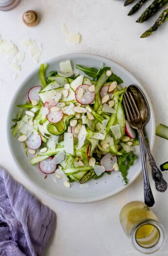 Shaved Zucchini Asparagus Salad loaded with raw greens, radishes, almonds & parmesan then tossed with a Lemon Vinaigrette. This light summer salad focuses on real ingredients and bringing out complex flavors!