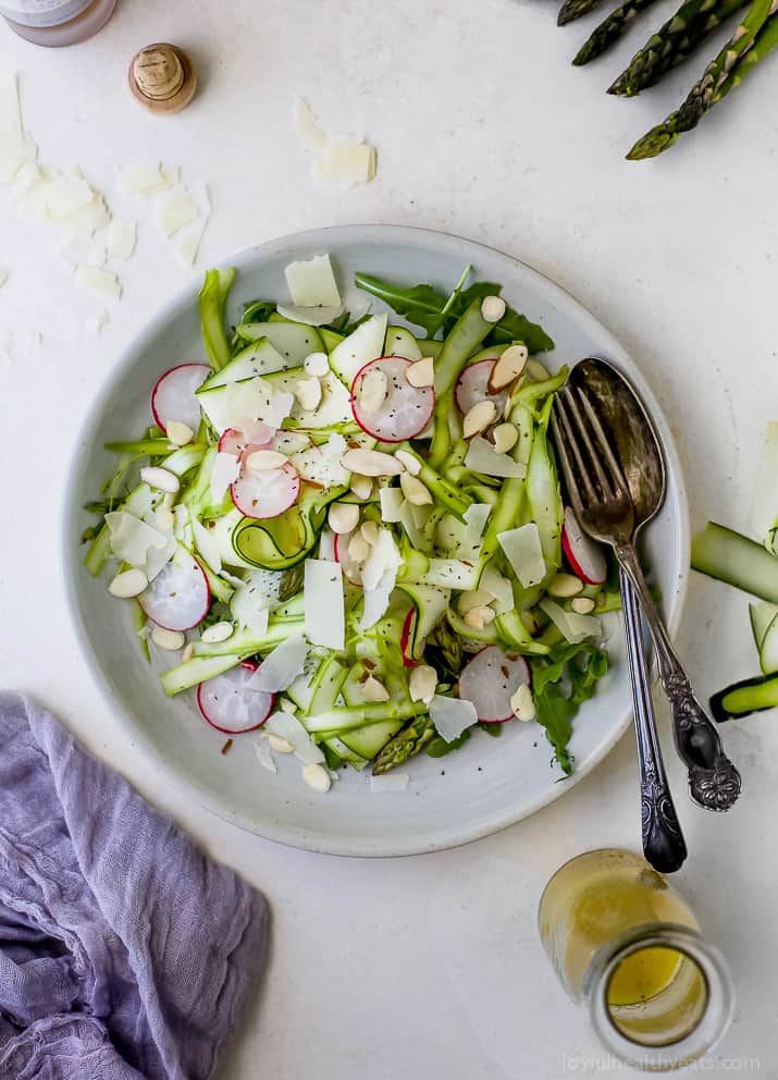 Shaved Zucchini Asparagus Salad loaded with raw greens, radishes, almonds & parmesan then tossed with a Lemon Vinaigrette. This light summer salad focuses on real ingredients and bringing out complex flavors!