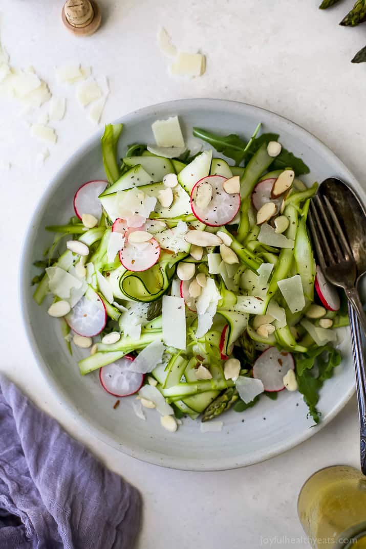 Shaved Zucchini Asparagus Salad loaded with raw greens, radishes, almonds & parmesan then tossed with a Lemon Vinaigrette. This light summer salad focuses on real ingredients and bringing out complex flavors!