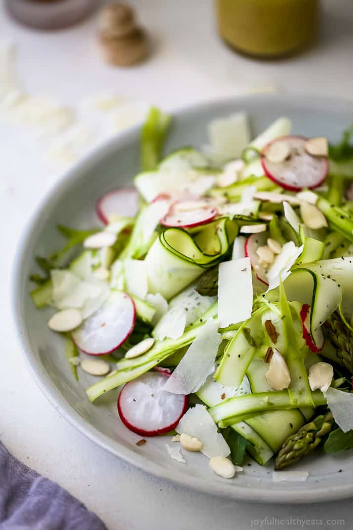 Shaved Zucchini Asparagus Salad loaded with raw greens, radishes, almonds & parmesan then tossed with a Lemon Vinaigrette. This light summer salad focuses on real ingredients and bringing out complex flavors!