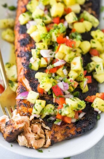 Grabbing a piece of flaky salmon with a fork.