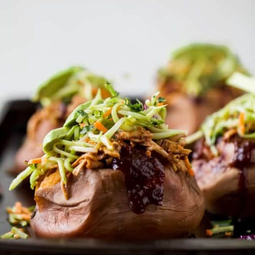 30 Minute BBQ Chicken Stuffed Sweet Potatoes topped with Broccoli Slaw. These Stuffed Sweet Potatoes are an easy gluten free recipe that's perfect for a quick weeknight dinner!