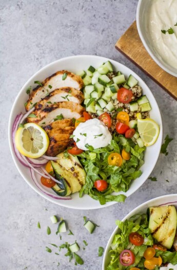 An overhead shot of a chicken shawarma bowl on a gray kitchen countertop