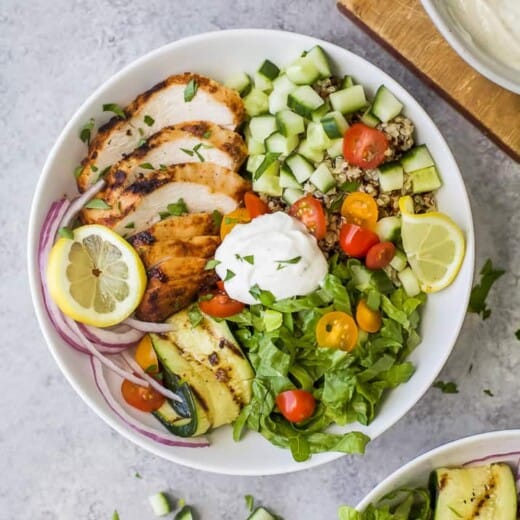 An overhead shot of a chicken shawarma bowl on a gray kitchen countertop