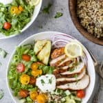 Healthy Chicken Shawarma Bowl served on a bed of quinoa and lettuce then topped with a Garlic Yogurt Sauce. This flavorful gluten free dinner recipe will be devoured in minutes.