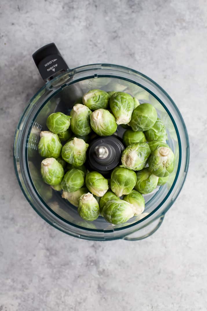 Top view of brussels sprouts in a food processor bowl
