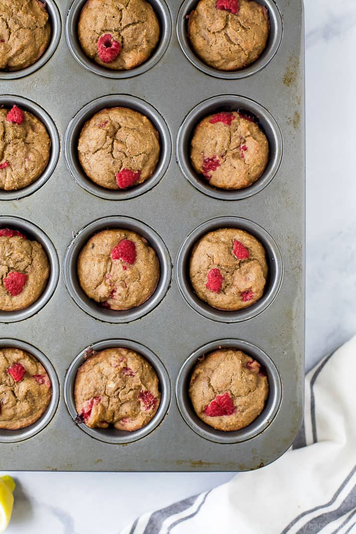 Flourless Lemon Raspberry Protein Muffins with 9 grams of protein per muffin! These berry bursting sugar free muffins are the perfect quick breakfast or post workout snack!