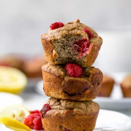 lemon raspberry protein muffins piled on top of one another