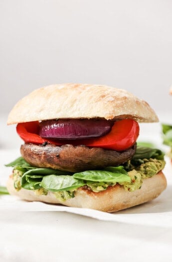 Close-up of portobello mushroom burger in a ciabatta bun.
