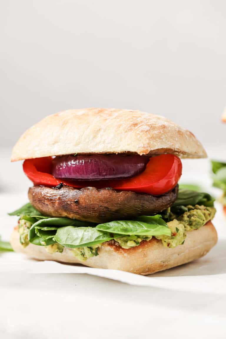 Close-up of portobello mushroom burger in a ciabatta bun.