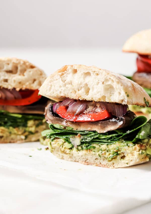 Close-up of the sliced burger with grilled veggies.