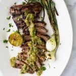 Tender grilled Carne Asada that's marinaded in a homemade Salsa Verde then charred to perfection for one authentic mexican dish! This flavorful low carb Carne Asada will be a hit at your house! Great for a weeknight dinner or dinner parties! #paleo #glutenfree