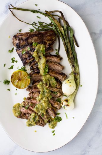 Tender grilled Carne Asada that's marinaded in a homemade Salsa Verde then charred to perfection for one authentic mexican dish! This flavorful low carb Carne Asada will be a hit at your house! Great for a weeknight dinner or dinner parties! #paleo #glutenfree