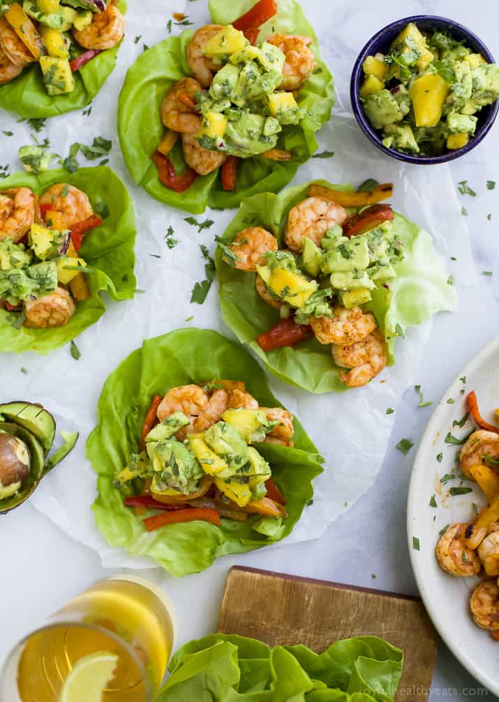 Easy 30 minute Grilled Shrimp Tacos topped with a fresh Mango Avocado Salsa. These flavor bursting gluten free tacos make the perfect light healthy dinner your family will love!