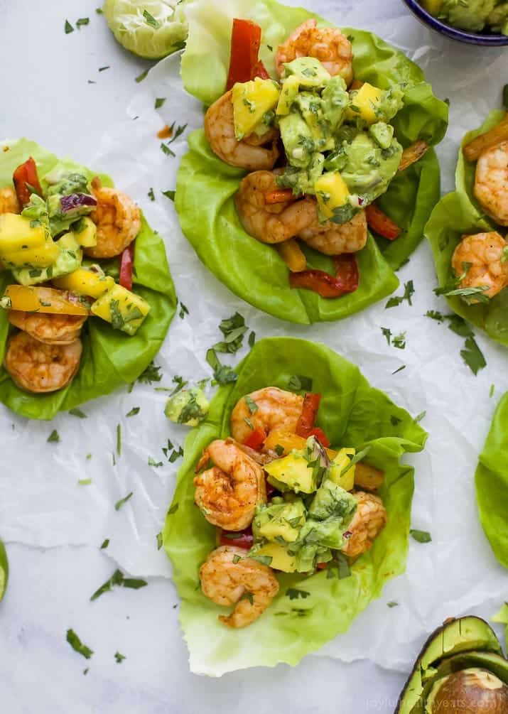 Easy 30 minute Grilled Shrimp Tacos topped with a fresh Mango Avocado Salsa. These flavor bursting gluten free tacos make the perfect light healthy dinner your family will love!