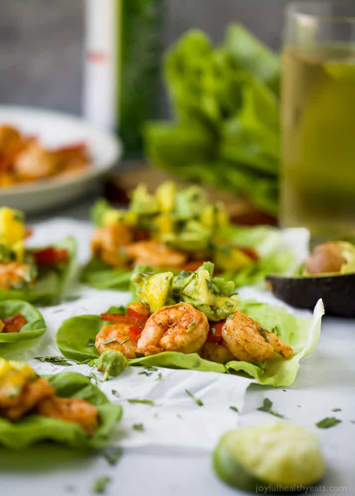 Easy 30 minute Grilled Shrimp Tacos topped with a fresh Mango Avocado Salsa. These flavor bursting gluten free tacos make the perfect light healthy dinner your family will love!