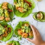 Easy 30 minute Grilled Shrimp Tacos topped with a fresh Mango Avocado Salsa. These flavor bursting gluten free tacos make the perfect light healthy dinner your family will love!