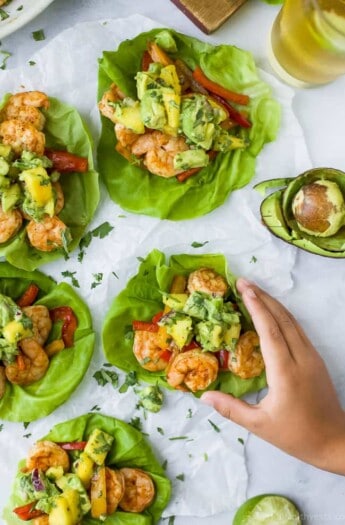 Easy 30 minute Grilled Shrimp Tacos topped with a fresh Mango Avocado Salsa. These flavor bursting gluten free tacos make the perfect light healthy dinner your family will love!