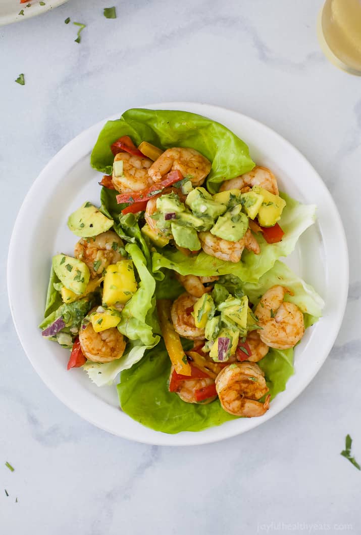 Easy 30 minute Grilled Shrimp Tacos topped with a fresh Mango Avocado Salsa. These flavor bursting gluten free tacos make the perfect light healthy dinner your family will love!