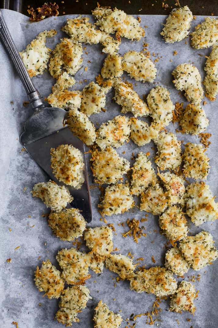 Crispy Baked Chicken Parmesan Bites on a parchment-lined baking sheet