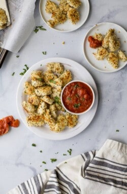 These fun Gluten Free Baked Chicken Parmesan Bites served with a homemade marinara sauce make the perfect kids school lunch, game day appetizer or quick dinner recipe! Easy, light and full of flavor - these chicken bites are a must make! #ad