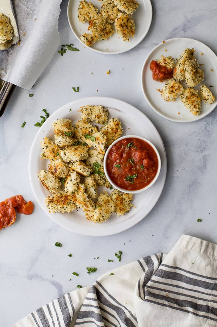 Parmesan chicken bites on a white plate.