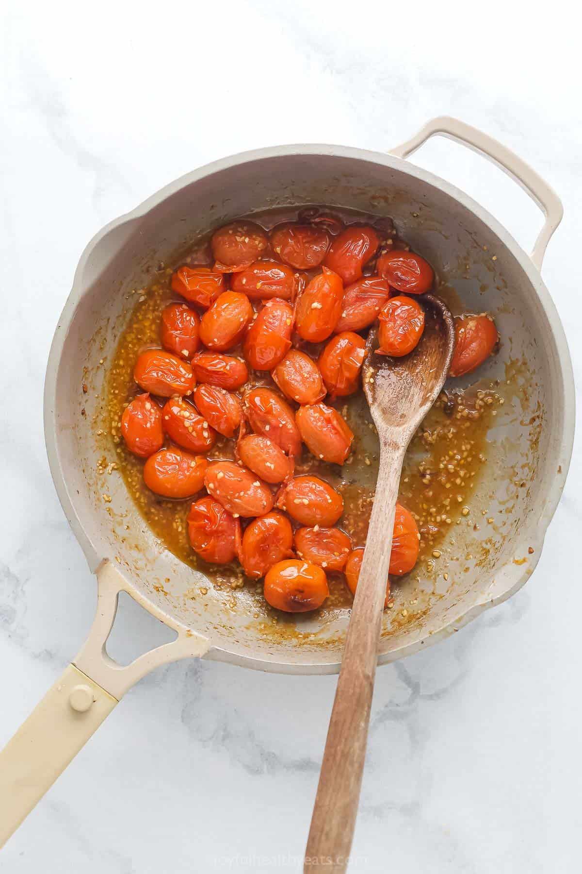 Cooking the tomatoes in the pan.