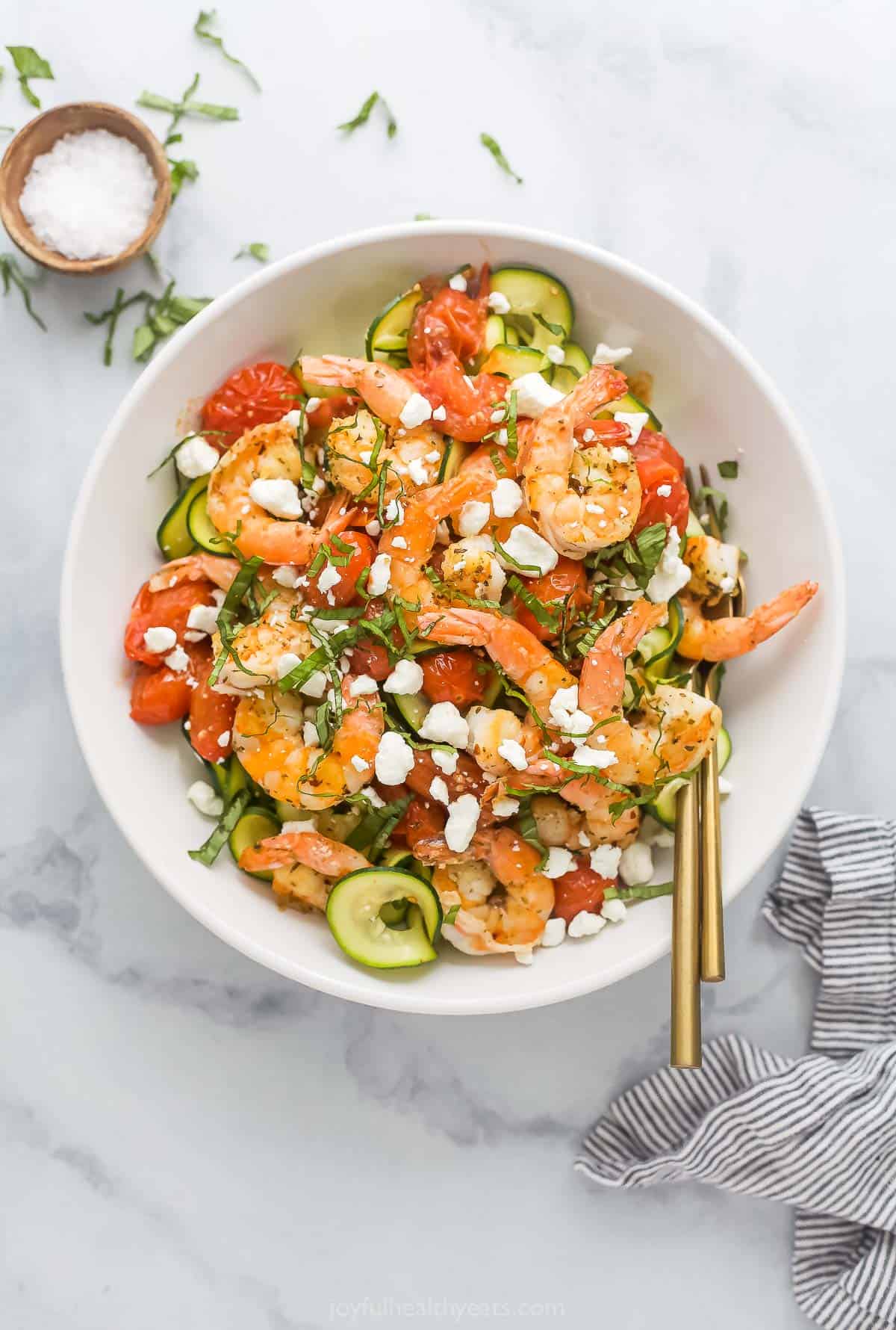 Bowl of creamy shrimp pasta with blistered tomatoes. 