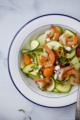 creamy shrimp pasta with blistered tomatoes in a bowl