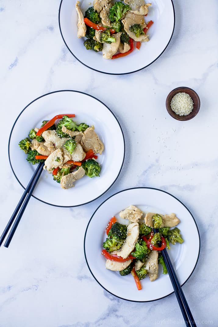 Top view of three plates of Chicken and Broccoli Stir Fry with chop sticks