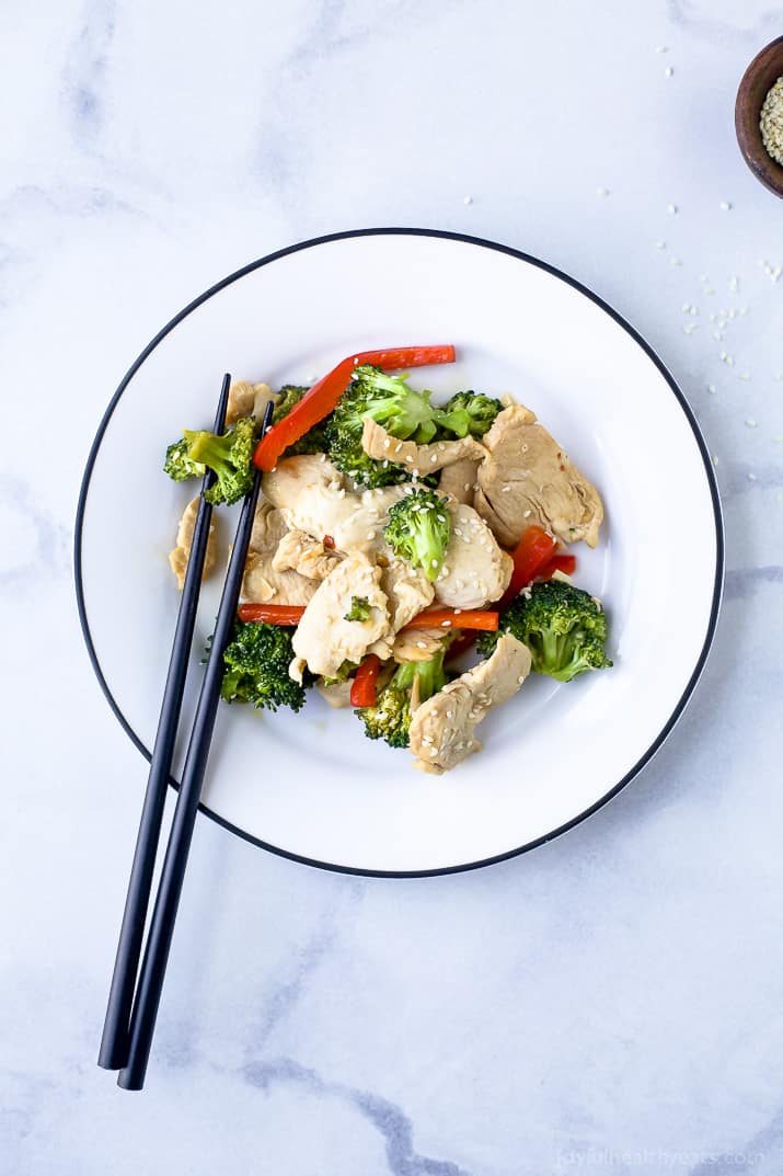 Top view of a plate of Chicken and Broccoli Stir Fry with chopsticks