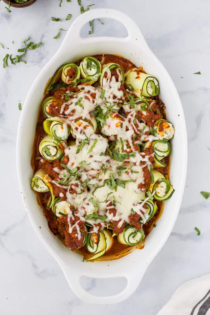 Low Carb Zucchini Lasagna Roll Ups with a homemade Meat Sauce - the perfect healthy comfort food! A ricotta filling wrapped up with zucchini noodles then topped with sauce and more cheese for one delicious bite!