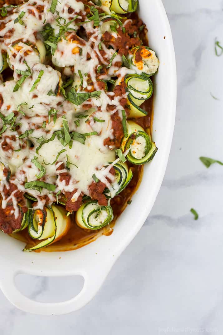 Low Carb Zucchini Lasagna Roll Ups with a homemade Meat Sauce - the perfect healthy comfort food! A ricotta filling wrapped up with zucchini noodles then topped with sauce and more cheese for one delicious bite!