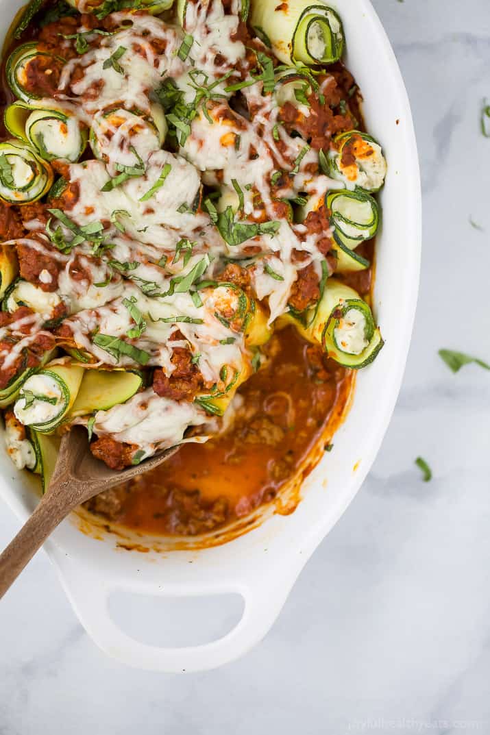 Low Carb Zucchini Lasagna Roll Ups with a homemade Meat Sauce - the perfect healthy comfort food! A ricotta filling wrapped up with zucchini noodles then topped with sauce and more cheese for one delicious bite!