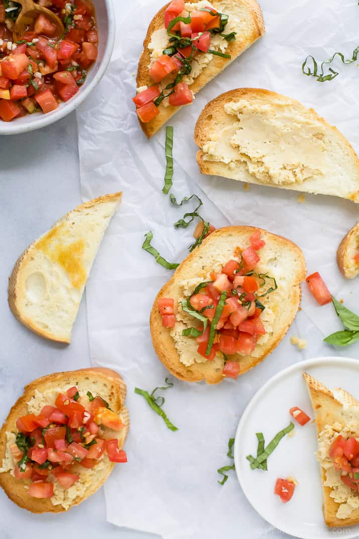 Some pieces of Smashed Chickpea Bruschetta Crostini on a table.