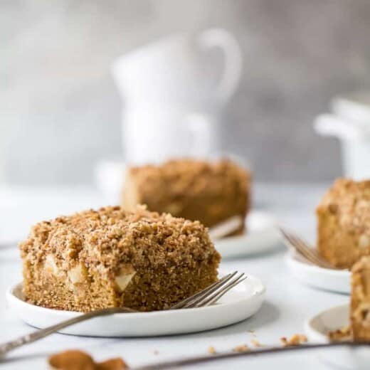 A slice of apple cinnamon coffee cake with chunks of Granny Smith apple.