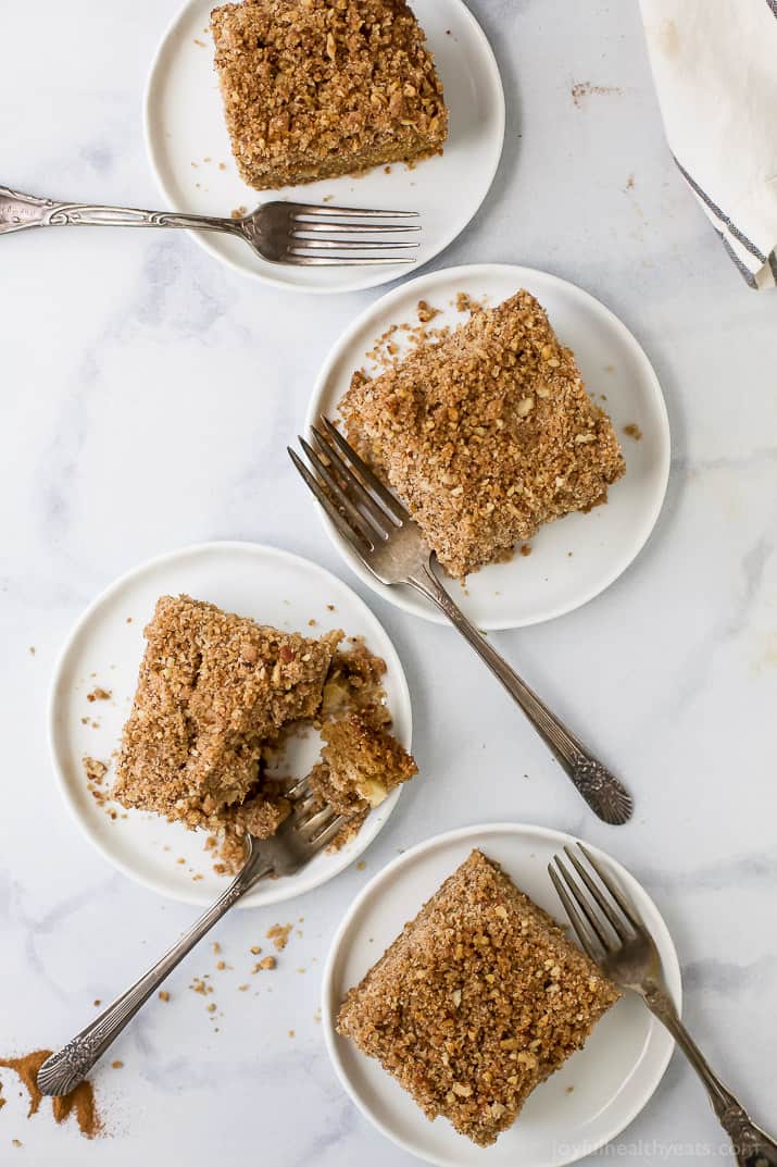 Top view of several squares of apple cinnamon coffee cake on plates