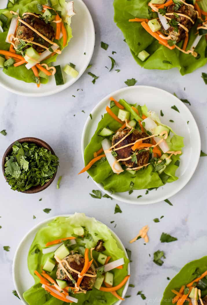 Top view of Banh Mi Lettuce Wraps with pickled vegetables and sriracha mayo on plates