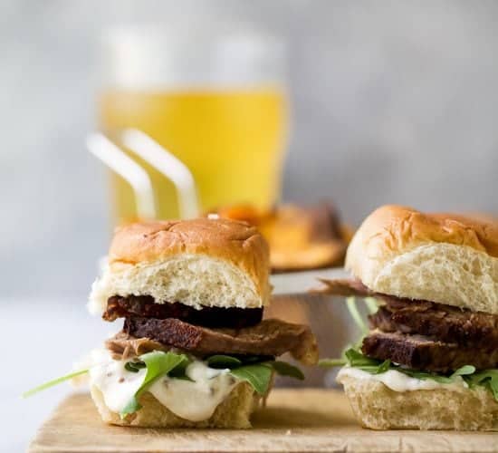 Beer Braised Slow Cooker Brisket Sliders tender moist brisket served on Hawaiian rolls then slathered with a creamy horseradish aioli. This easy flavorful appetizer is sure to be devoured as soon as it hits the table!
