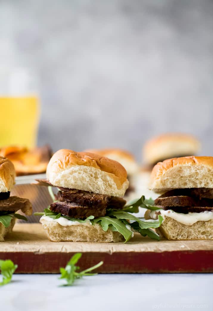 Beer Braised Slow Cooker Brisket Sliders tender moist brisket served on Hawaiian rolls then slathered with a creamy horseradish aioli. This easy flavorful appetizer is sure to be devoured as soon as it hits the table!