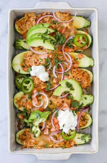 Easy Chicken Enchilada Zucchini Boats with red chili sauce and melted cheese.  A 30 minute meal that's gluten free, low carb, high protein and perfect for a weeknight dinner.