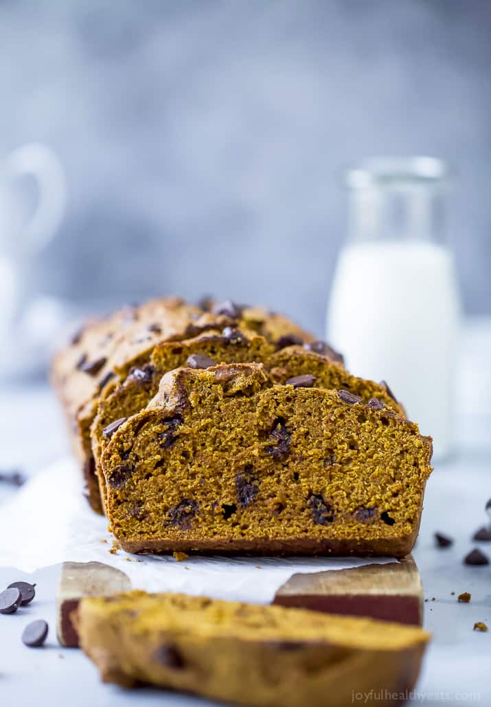 A loaf of chocolate chip pumpkin bread with three slices removed