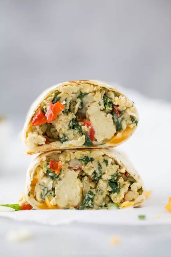 Freezer breakfast burrito cut in half and stacked.