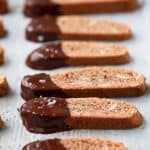 Gluten Free Amaretto Biscotti a lightly toasted sweet treat made with almond flour, amaretto liquor then dipped in dark chocolate. These crispy crunchy biscotti are perfect for dunking in a warm cup of coffee.