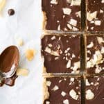 healthy no bake almond joy bars with a spoon of chocolate next to them